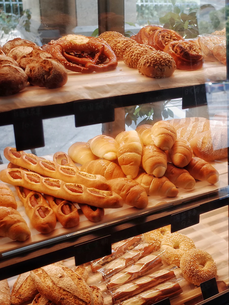 Pastry case full of croissants and buns