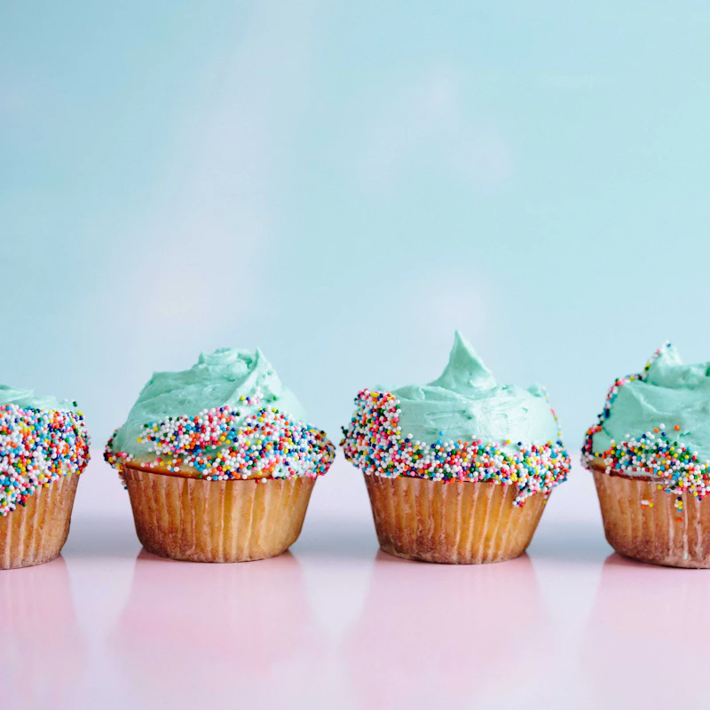 A row of frosted cupcakes